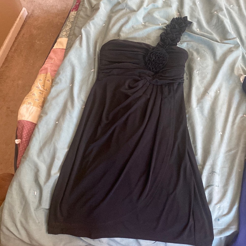 Women’s short cocktail dress. Black with one strap and flower in the front.